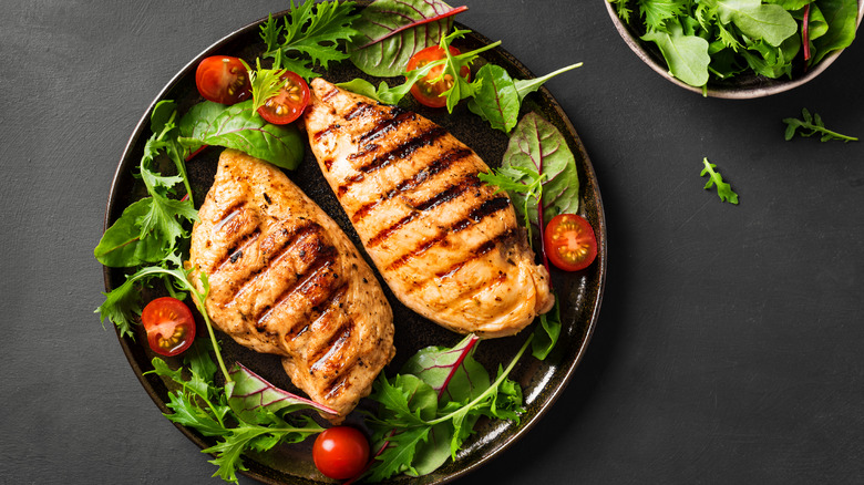 Grilled chicken breasts on salad