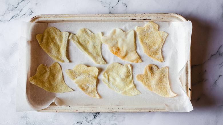 ghost shaped pita chips on baking sheet