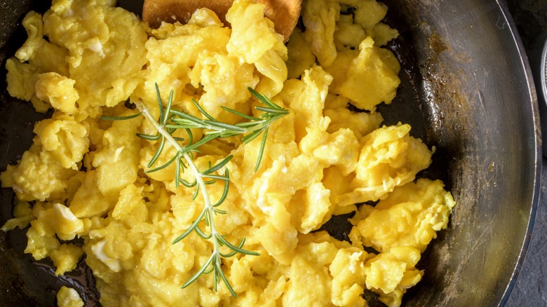 Top-down view of scrambled eggs in a pan