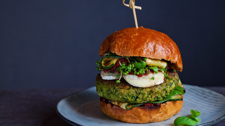 pesto burger with vegetable and sund dried tomato toppings