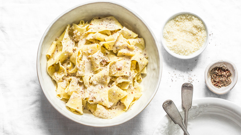 bowl of wide pasta noodles with cheese and pepper