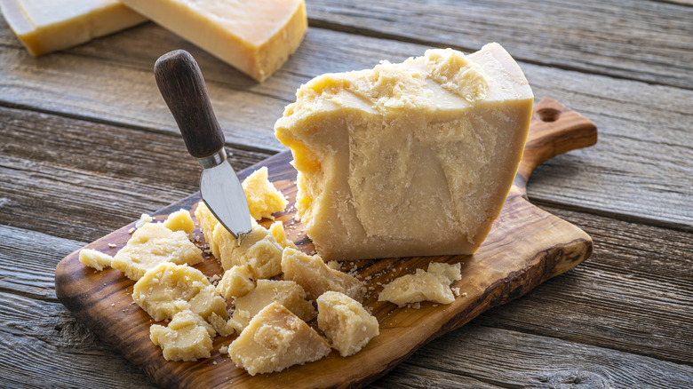 Chunk of parmesan cheese on cutting board