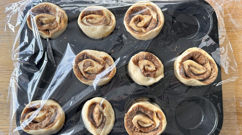 covered buns rising in pan