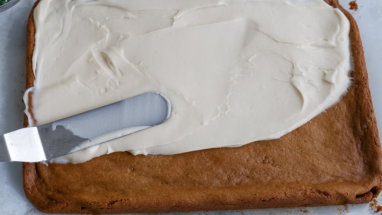 spreading frosting on cookie bars