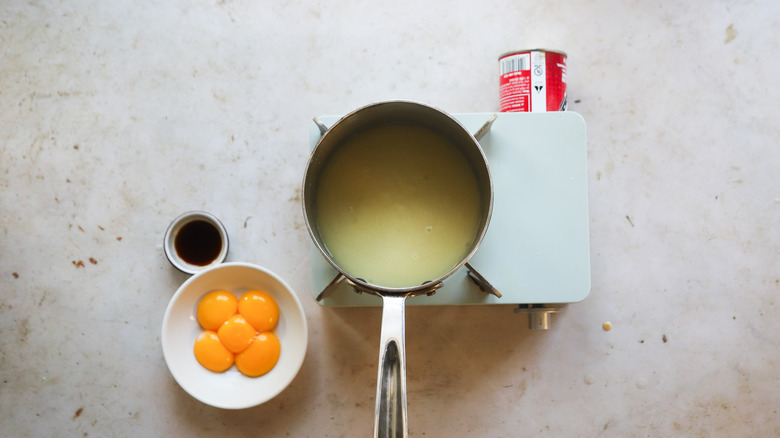 Adding eggs yolks to pot