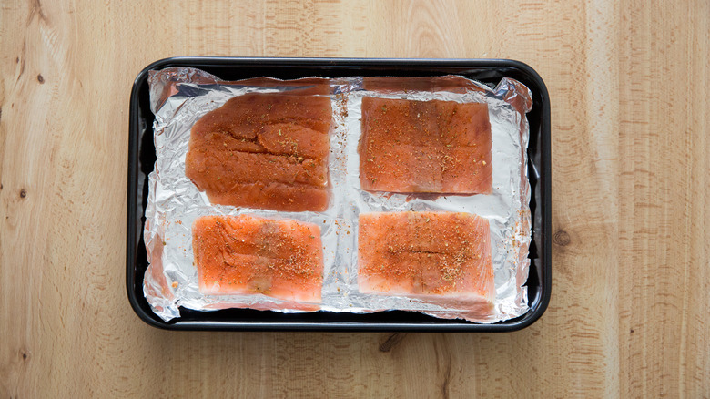 raw salmon in baking pan