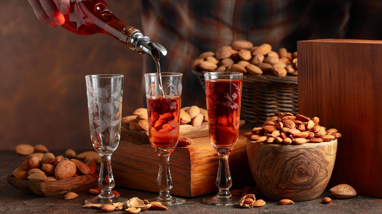 Pouring almond liqueur into glasses