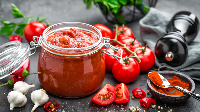 salsa in jar with tomatoes and garlic