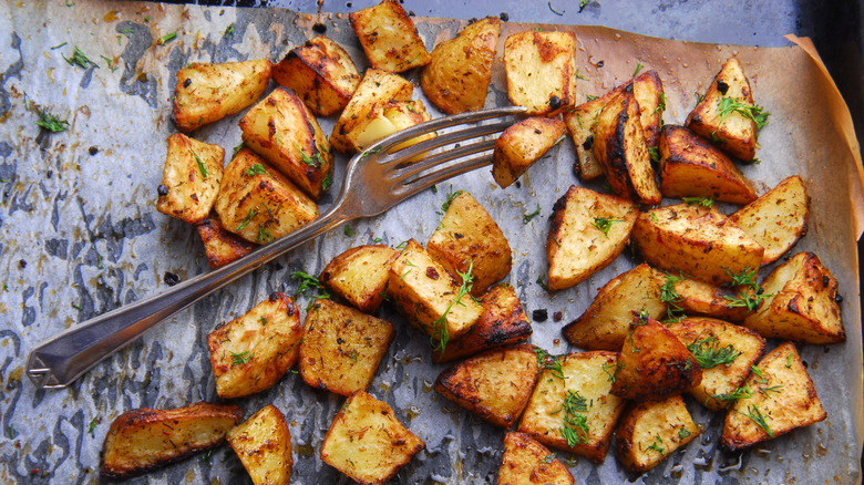 Roasted potatoes with fork