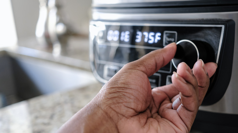 cook operating air fryer