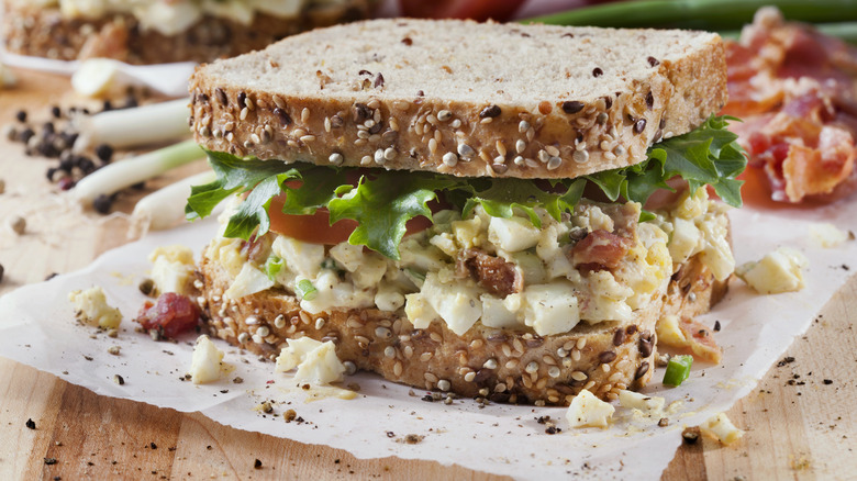 Egg salad sandwich with bacon, lettuce and tomato 