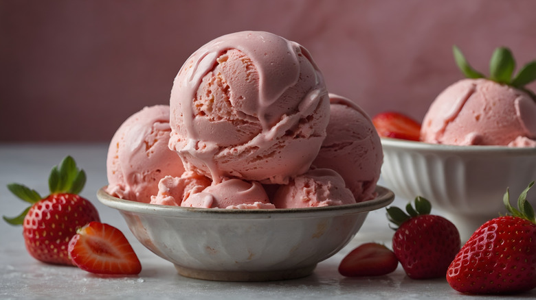 Scoops of strawberry ice cream and fresh strawberries