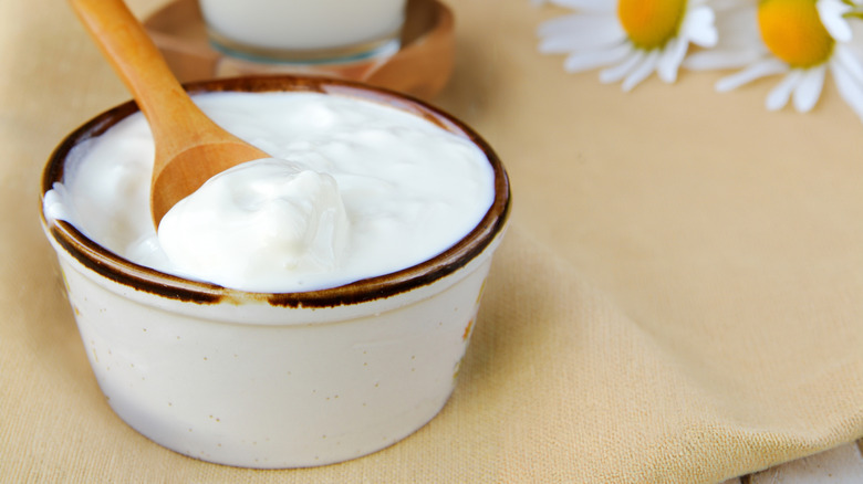 Bowl of sour cream and wooden spoon