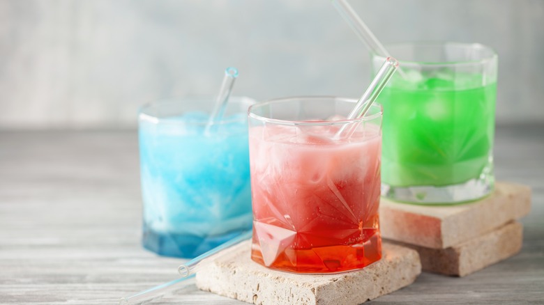 blue, red, and green sodas with creamer