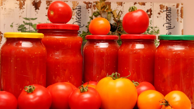 tomatoes and juice in jars