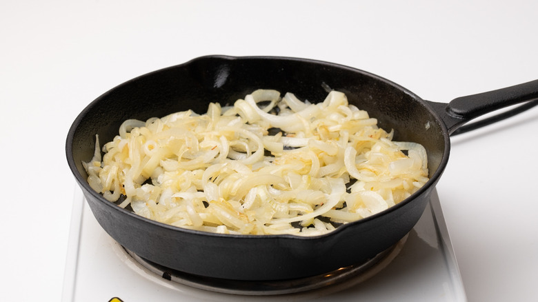 sautéing onions in a pan