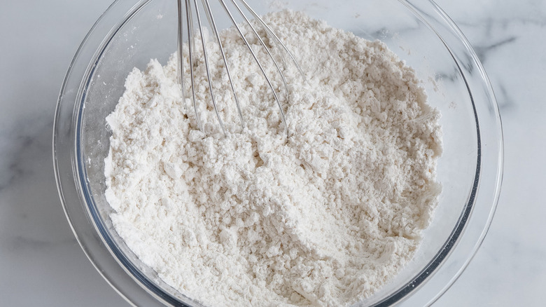 flour mixture in glass bowl with whisk