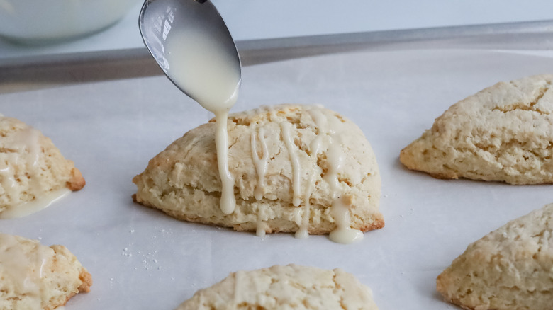 drizzling eggnog glaze on scones