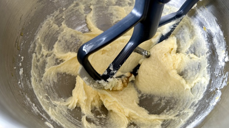 Beating donut batter in bowl