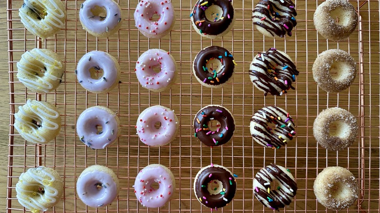 Assorted mini donuts on wire rack