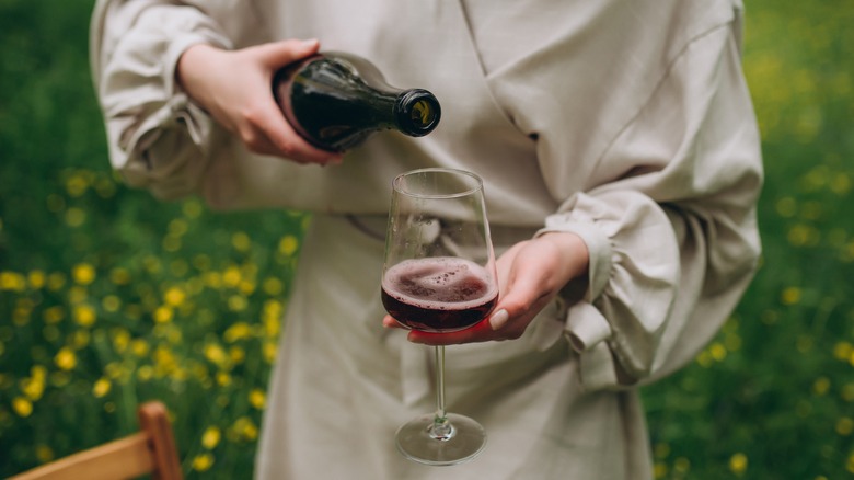 Woman pouring wine in glass