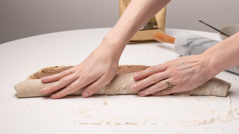 rolling up cinnamon roll dough