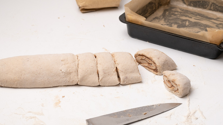 slicing gluten-free cinnamon rolls