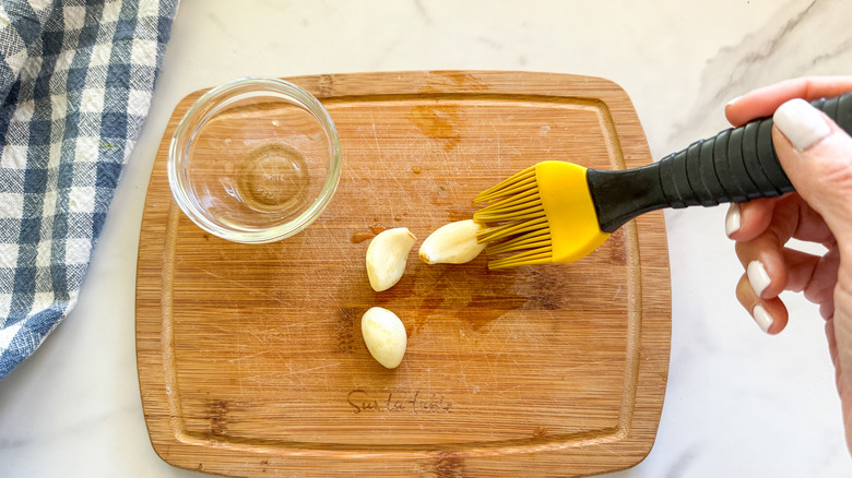 brushing garlic with oil