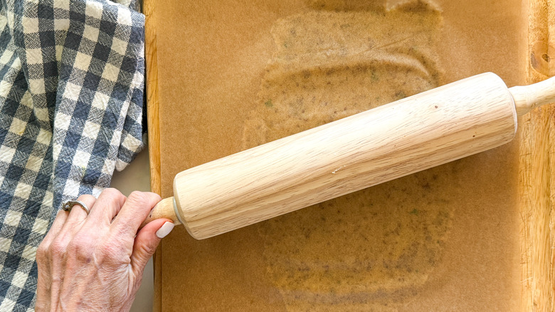 hands rolling out dough