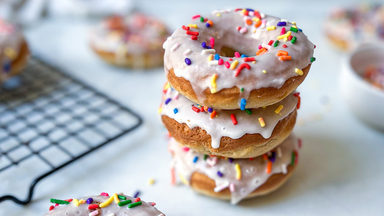 glazed sprinkled donuts on plate