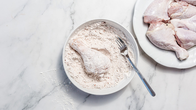 drumstick in gluten-free flour mix in bowl with fork