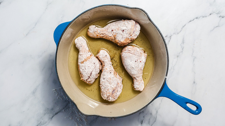 Drumsticks in pan with oil