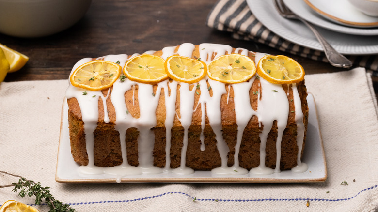 lemon thyme zucchini loaf bread with glaze on plate