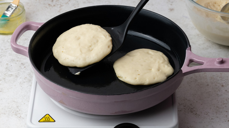 uncooked pancakes in a frying pan