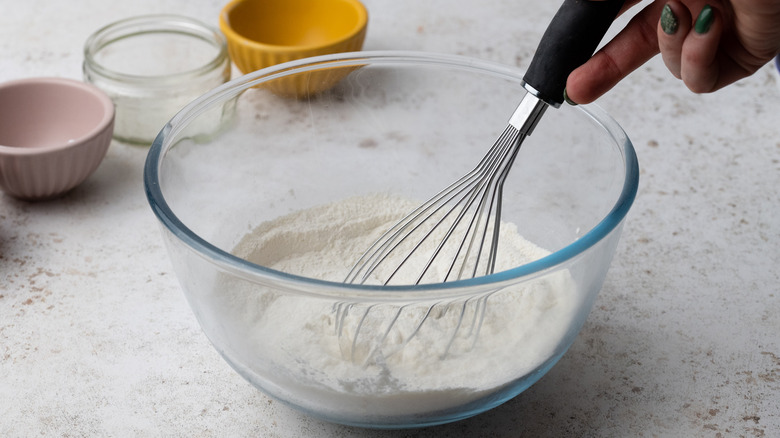 whisking dry ingredients in glass bowl 