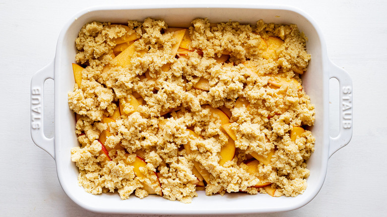 unbaked peach crisp in pan