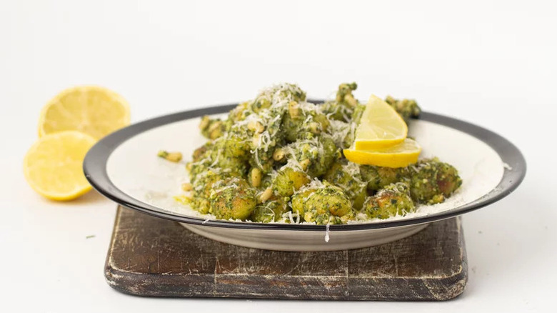 Fried pesto gnocchi, parmesan, lemon in bowl