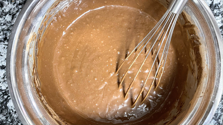 whisking chocolate batter in bowl