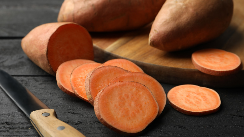 cut sweet potatoes next to a knife