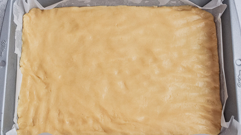 dough pressed into baking dish