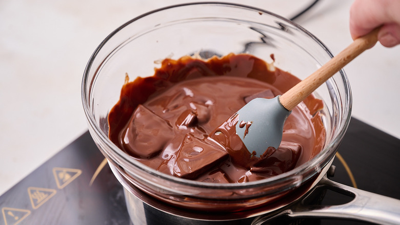 stirring melted chocolate in bowl