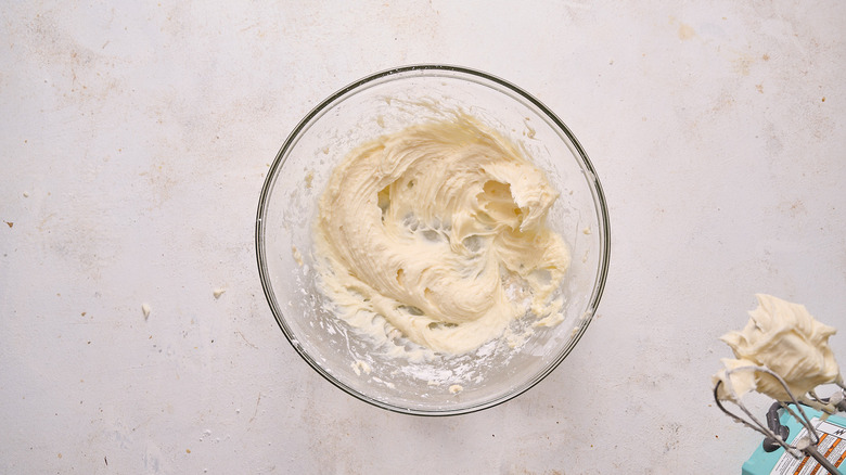 beating cream cheese and sugar in bowl