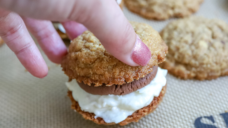 tops being added to gooey s'mores sandwich cookies
