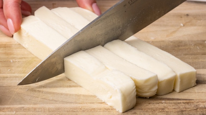 knife cutting mozzarella sticks