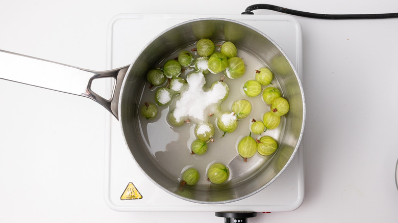 saucepan containing gooseberries and sugar