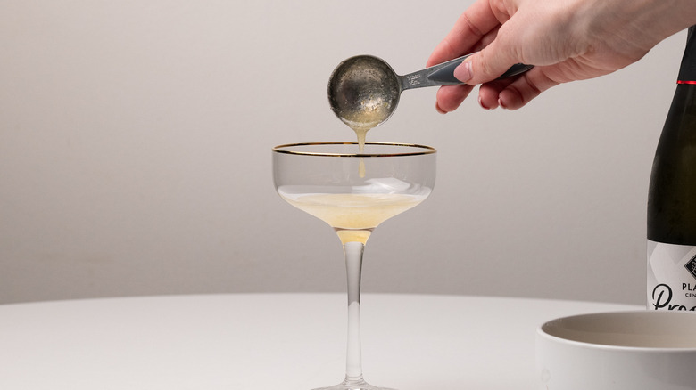 pouring gooseberry syrup in glass