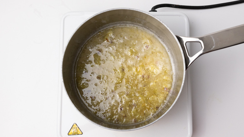 gooseberry syrup simmering in pan