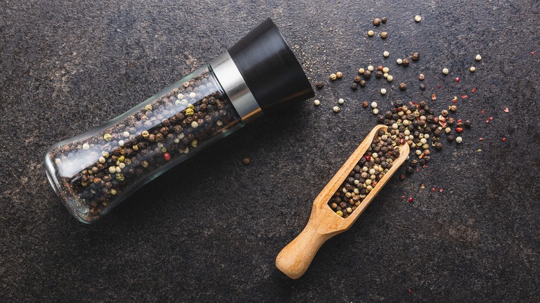 Pepper mill and peppercorns 