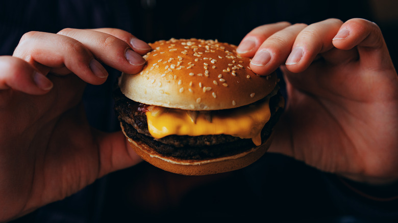 Man eating cheeseburger