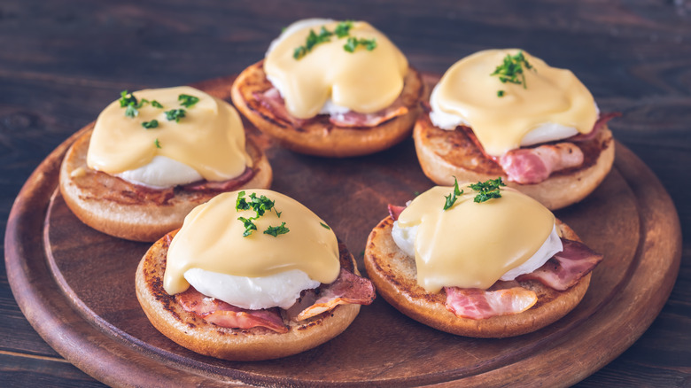 eggs Benedict on wooden board